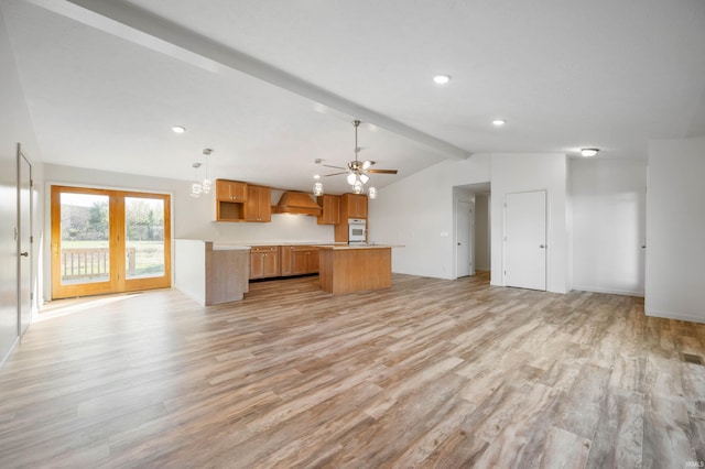 kitchen featuring light hardwood / wood-style floors, white oven, decorative light fixtures, and vaulted ceiling with beams