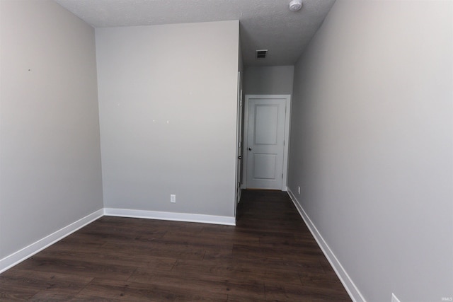3088 Ashdon Dr, Newburgh, IN 47630 - spare room featuring baseboards, dark wood-style flooring, visible vents, and a textured ceiling