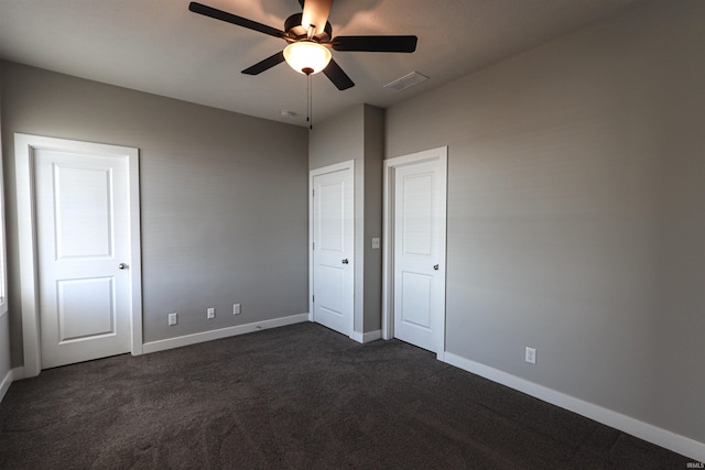 3088 Ashdon Dr, Newburgh, IN 47630 - unfurnished bedroom with dark colored carpet, baseboards, a ceiling fan, and visible vents