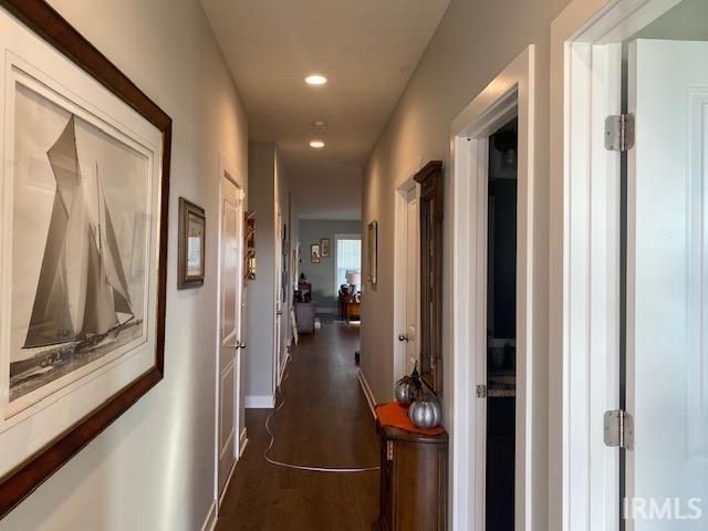 hallway with dark hardwood / wood-style flooring