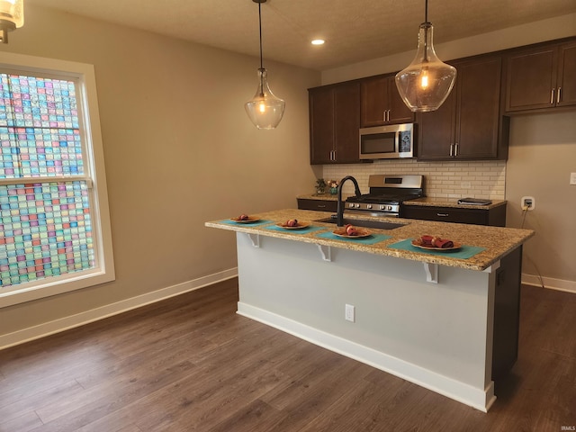 3088 Ashdon Dr, Newburgh, IN 47630 - kitchen featuring stainless steel appliances, tasteful backsplash, dark wood-type flooring, and dark brown cabinets