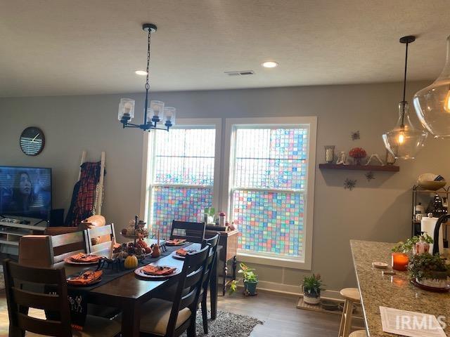 dining room featuring hardwood / wood-style flooring and a chandelier