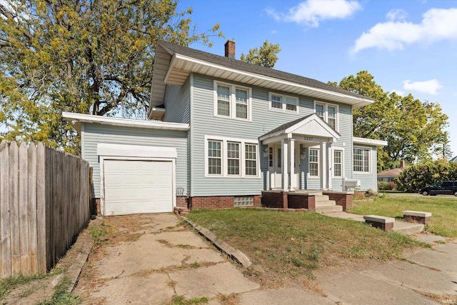 colonial house featuring a front yard and a garage