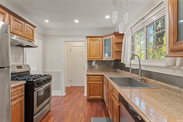 kitchen with tasteful backsplash, sink, dark hardwood / wood-style flooring, stainless steel appliances, and pendant lighting