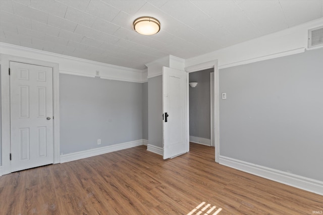 interior space with hardwood / wood-style floors and crown molding