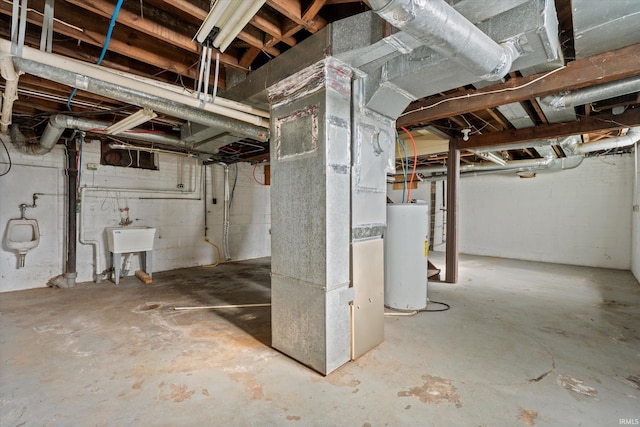 basement featuring water heater, sink, and heating unit