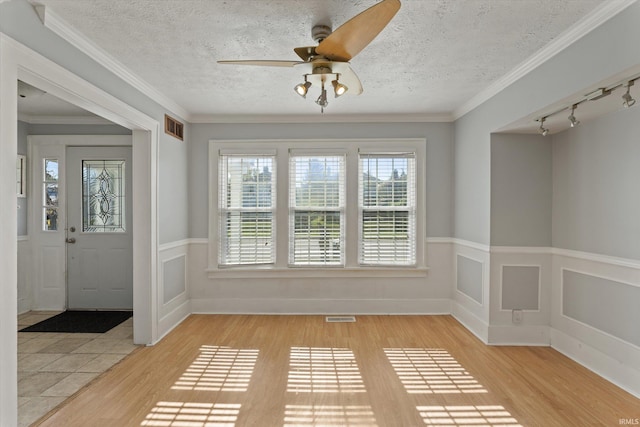 unfurnished sunroom with ceiling fan