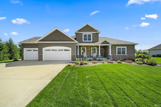 craftsman-style home with a front yard, a porch, and a garage