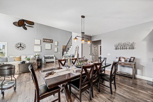 dining area with dark hardwood / wood-style floors and ceiling fan with notable chandelier