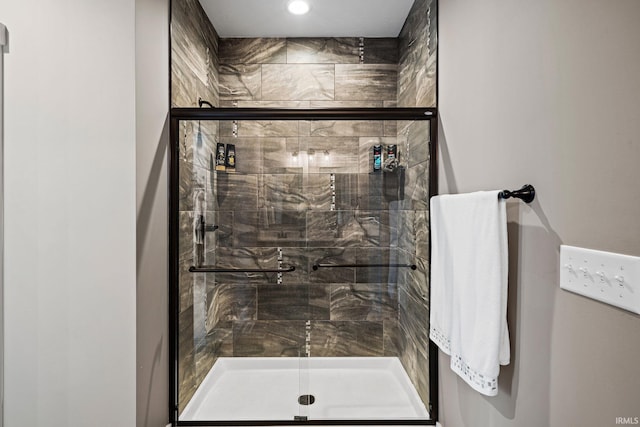 bathroom featuring a shower with door