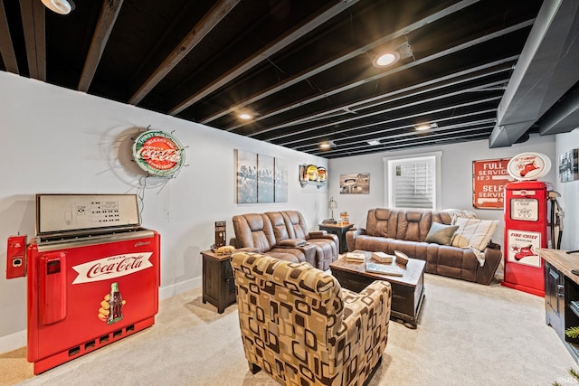 living room with beamed ceiling and light colored carpet