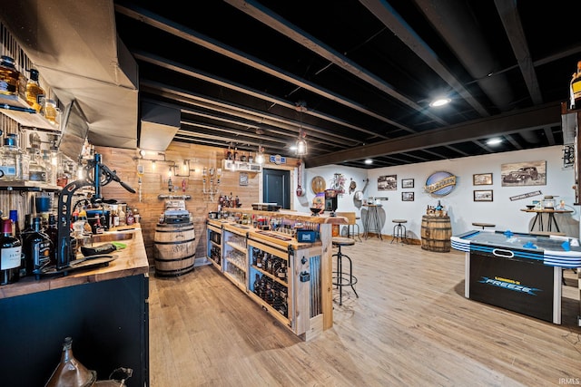 interior space with wood counters, hardwood / wood-style flooring, and a breakfast bar area