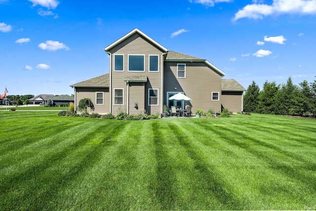 rear view of property featuring a yard