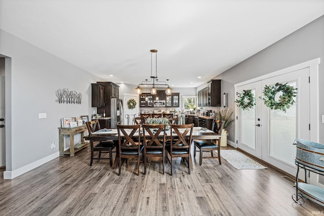 dining space with french doors and hardwood / wood-style flooring