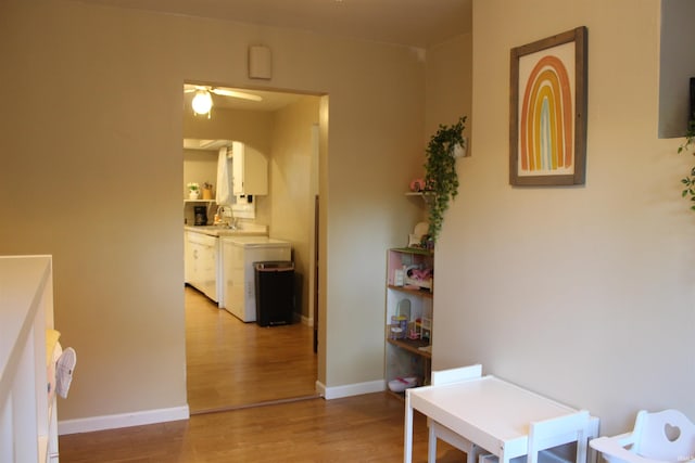 hall featuring light hardwood / wood-style floors and sink