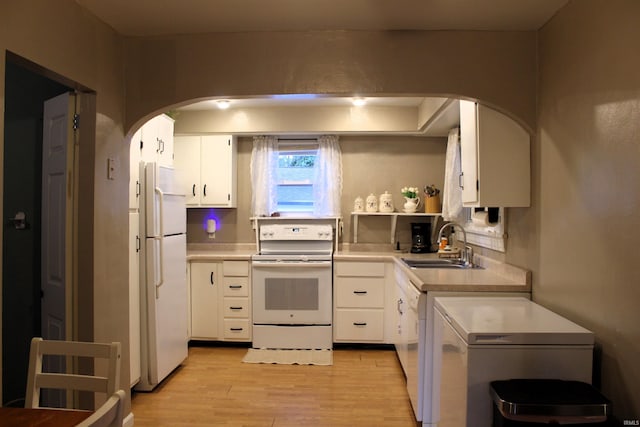 kitchen with white cabinets, white appliances, light hardwood / wood-style floors, and sink