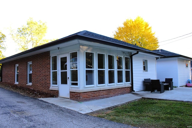 view of property exterior with a patio area