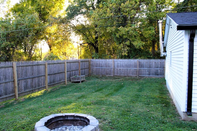 view of yard with a fire pit