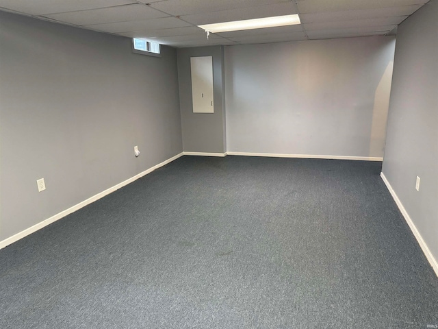 empty room with a paneled ceiling and carpet floors