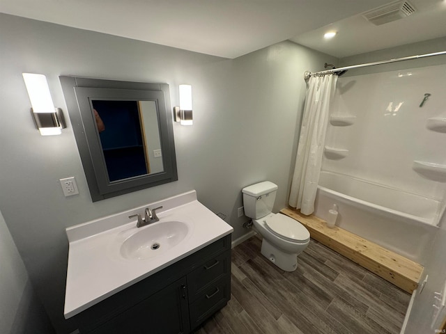 full bathroom featuring vanity, toilet, hardwood / wood-style flooring, and shower / bath combo with shower curtain