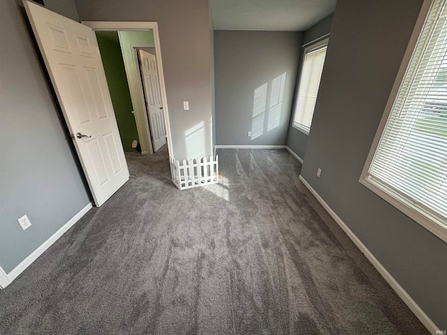 unfurnished bedroom featuring dark colored carpet