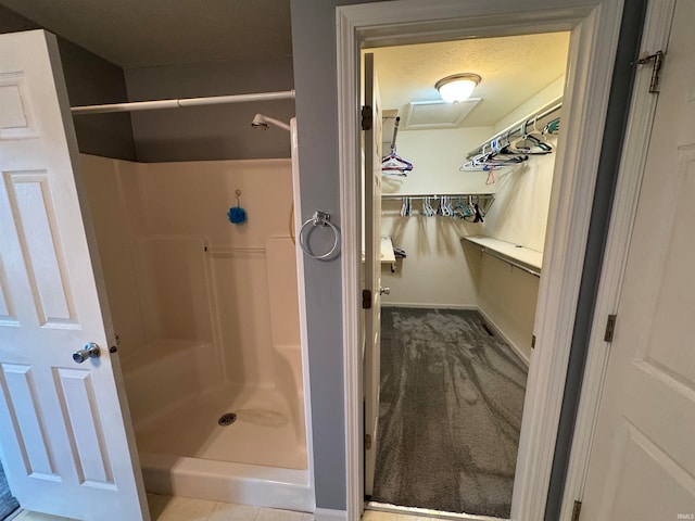 bathroom featuring a shower and a textured ceiling