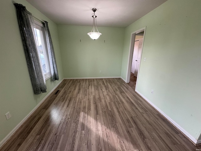 unfurnished dining area with dark hardwood / wood-style flooring