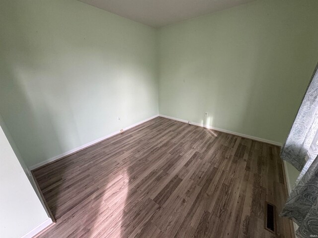 unfurnished room featuring hardwood / wood-style floors