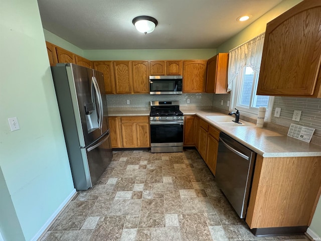 kitchen with sink, decorative backsplash, and stainless steel appliances