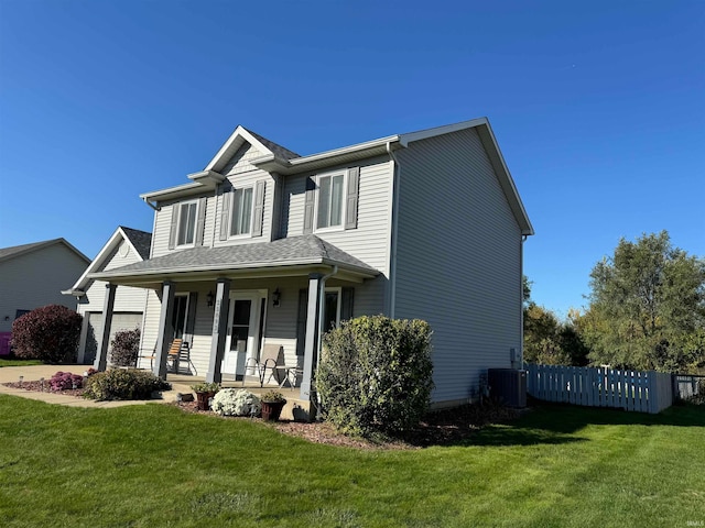 view of front of property with covered porch, a front lawn, and central air condition unit