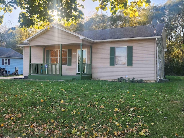 single story home with a porch and a front lawn