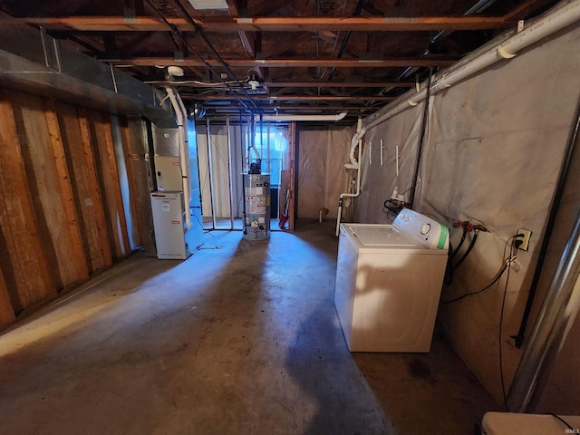 basement with gas water heater, heating unit, and washer / clothes dryer