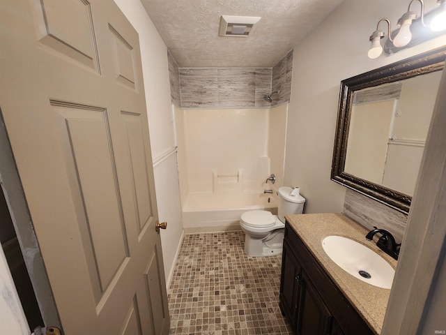 full bathroom with vanity, a textured ceiling, toilet, and tub / shower combination