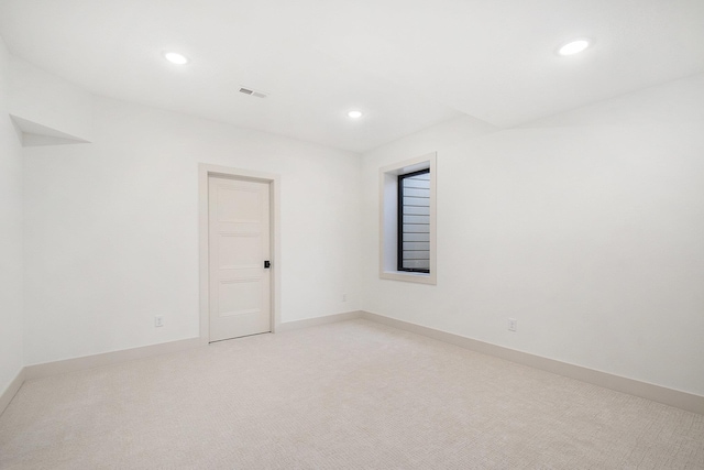 empty room with recessed lighting, light carpet, and baseboards