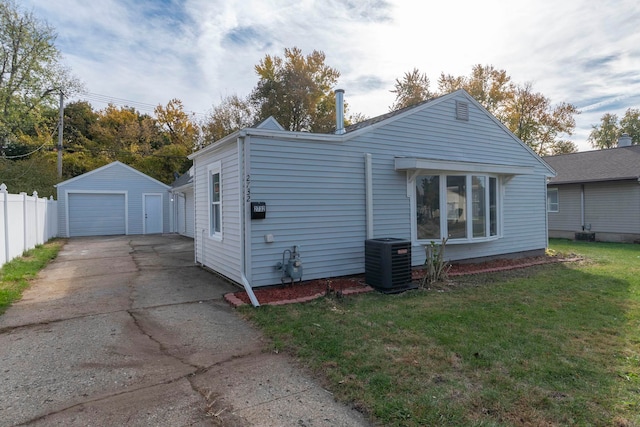 exterior space with an outbuilding, a yard, cooling unit, and a garage