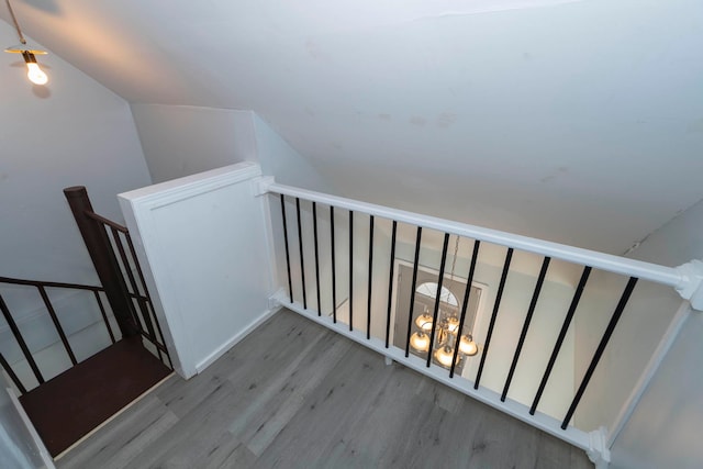 staircase featuring hardwood / wood-style floors and vaulted ceiling