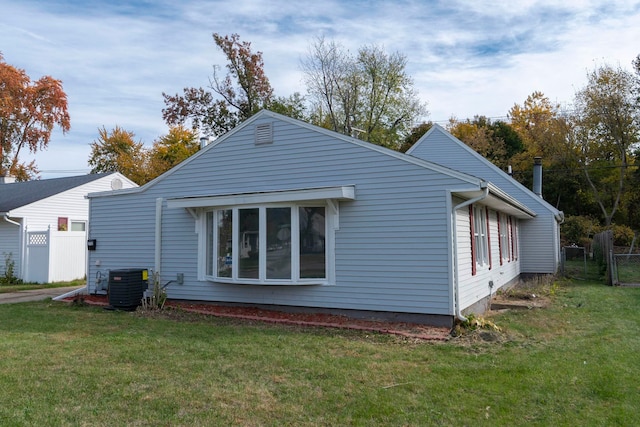 view of home's exterior featuring central air condition unit and a lawn