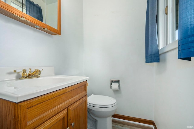 bathroom with vanity, hardwood / wood-style floors, and toilet