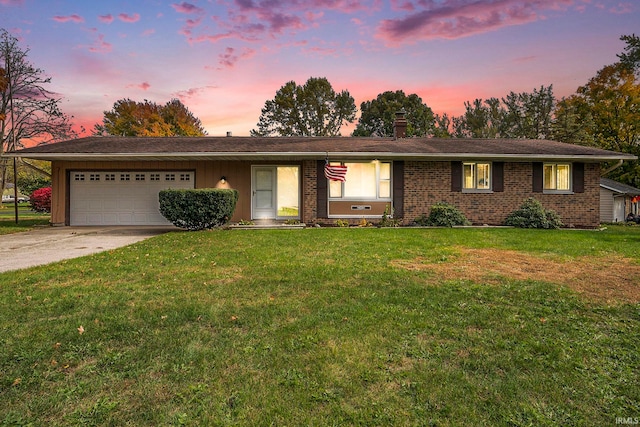 single story home featuring a yard and a garage