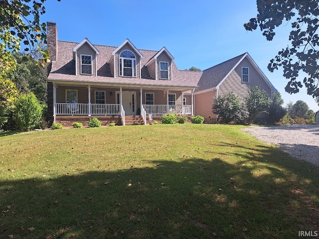 cape cod house with a front yard and covered porch