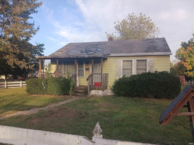 bungalow-style home featuring a front lawn and a playground