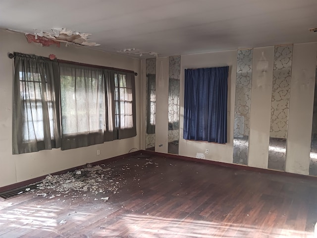 unfurnished room featuring hardwood / wood-style flooring