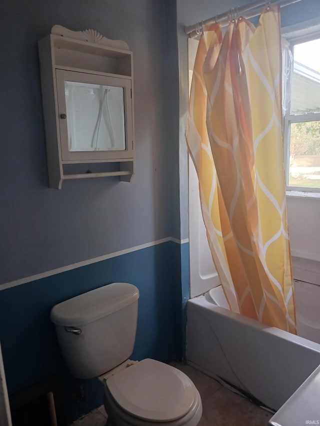 bathroom with toilet and shower / bathtub combination with curtain