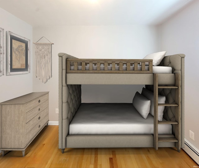 bedroom featuring light hardwood / wood-style flooring and a baseboard heating unit