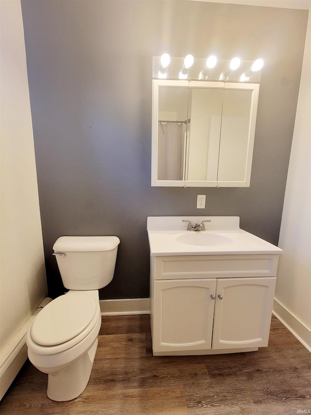 bathroom with vanity, hardwood / wood-style flooring, and toilet