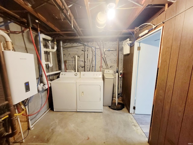 laundry area with washer and dryer and water heater