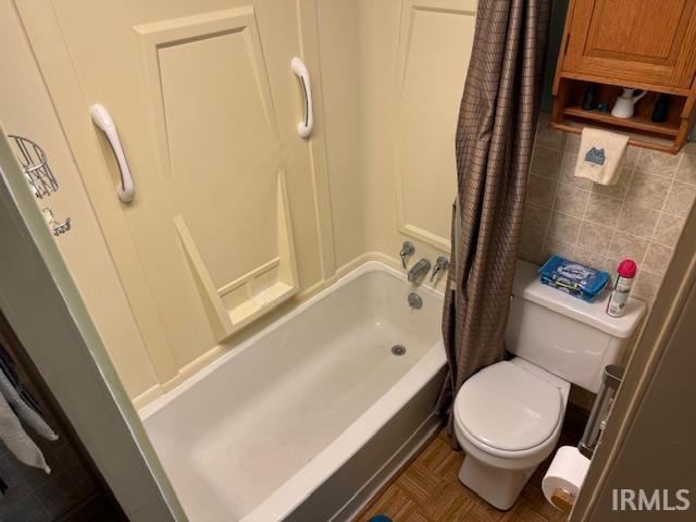 bathroom with toilet, tasteful backsplash, and shower / tub combo