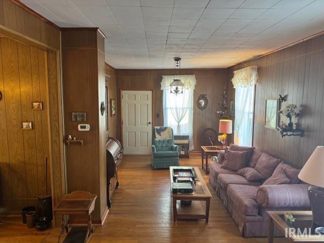 living room with wood walls and hardwood / wood-style floors