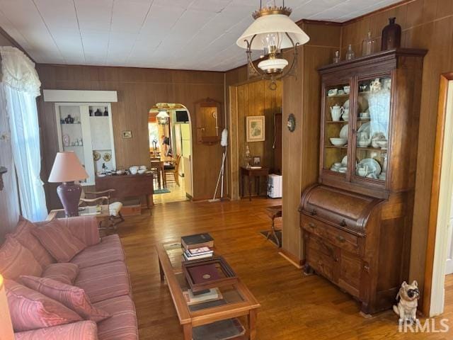 living room featuring hardwood / wood-style flooring and wooden walls