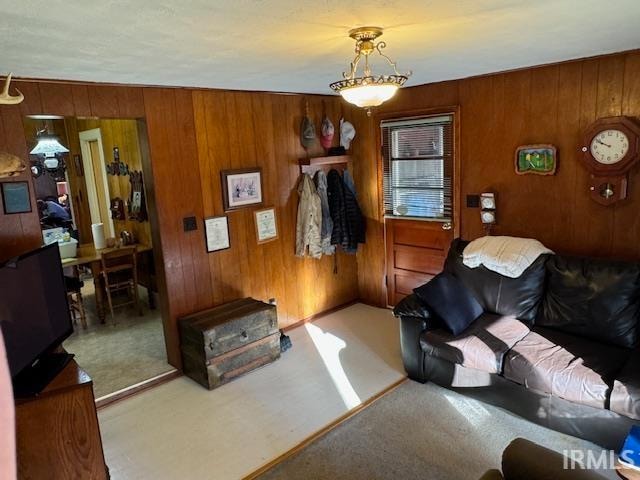 living room with carpet flooring and wooden walls